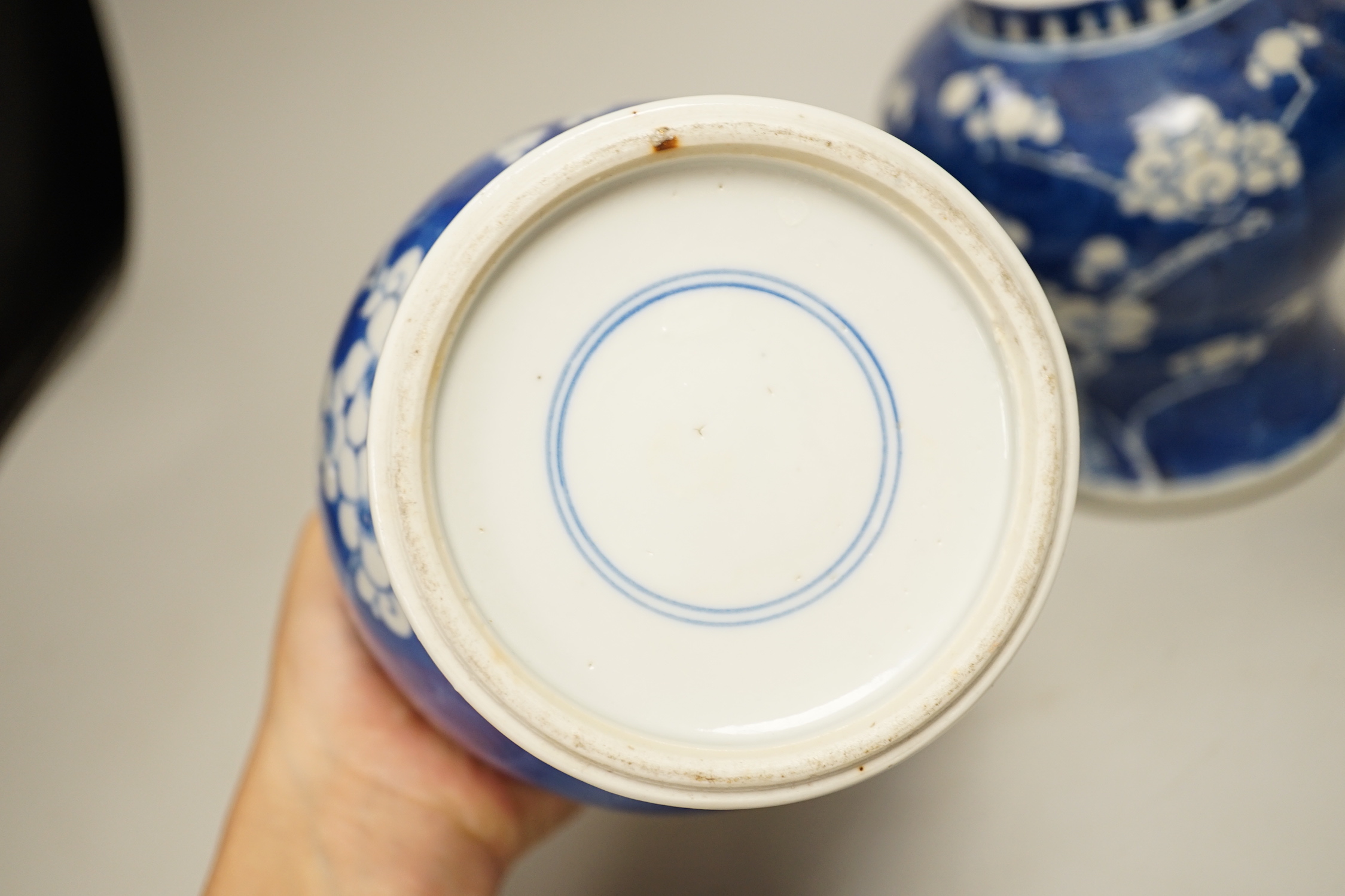 A pair of Chinese blue and white prunus pattern vases and covers, 21cm high